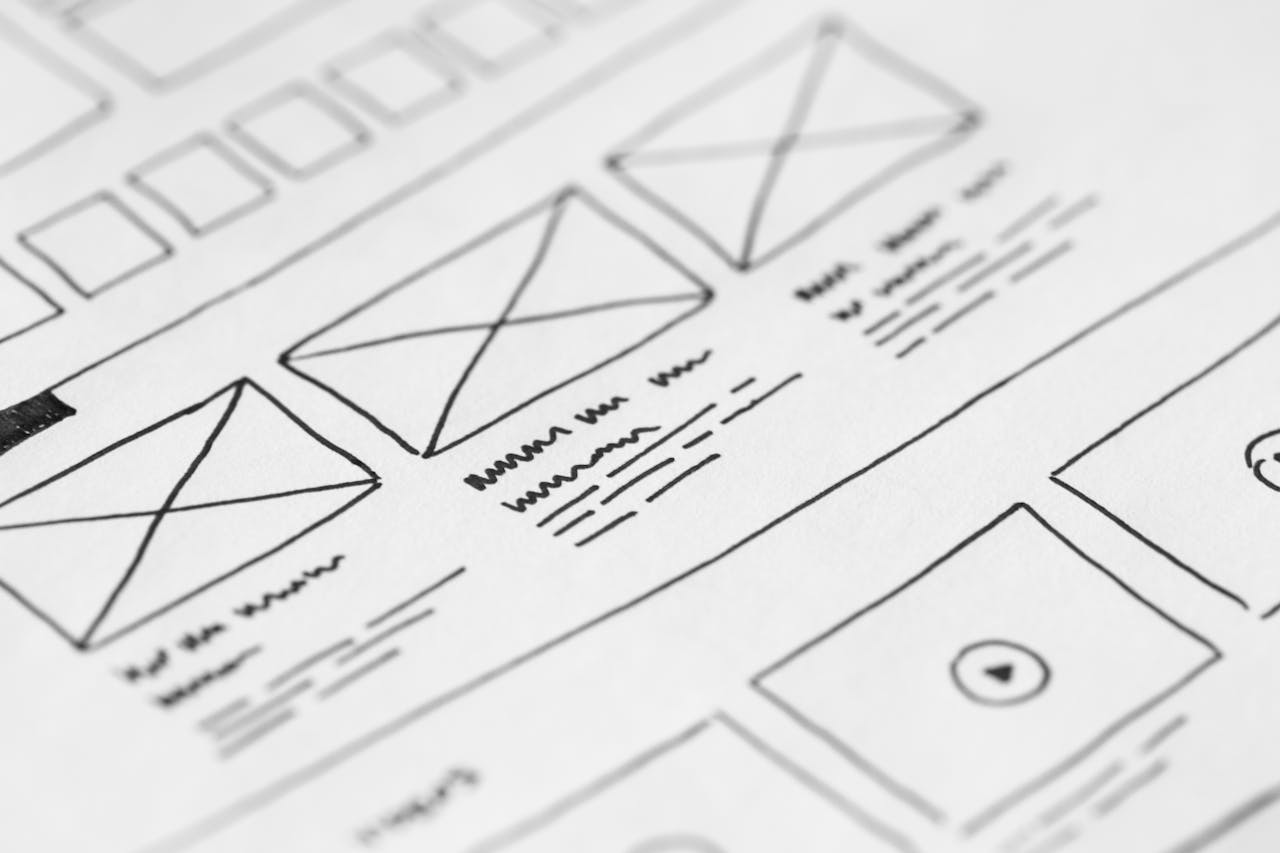 services-01 Detailed close-up of a hand-drawn wireframe design on paper for a UX project.